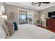 Comfortable main bedroom with natural light, wood floors, and view of the outdoor patio at 1100 Cordova Ne Blvd, St Petersburg, FL 33704
