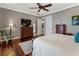 Comfortable main bedroom with modern ceiling fan, wood floors, and natural light at 1100 Cordova Ne Blvd, St Petersburg, FL 33704