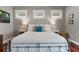 This bedroom is brightly lit by three windows, and it features hardwood floors and a metal-framed bed at 1100 Cordova Ne Blvd, St Petersburg, FL 33704