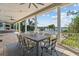 Covered outdoor dining area with ceiling fans, an outdoor fireplace, and beautiful water views at 1100 Cordova Ne Blvd, St Petersburg, FL 33704