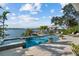 Resort-style pool and spa overlooking the waterfront, surrounded by lush landscaping and lounge chairs at 1100 Cordova Ne Blvd, St Petersburg, FL 33704