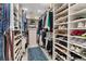 Walk-in closet featuring custom shelving, storage, blue rug, and lots of natural light at 1100 Cordova Ne Blvd, St Petersburg, FL 33704