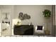 Stylishly staged living room with black dresser, decorative wall art, modern chair, and indoor potted tree at 11749 E 74Th Cir, Palmetto, FL 34221