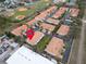 Expansive aerial view of condo complex featuring a pool, mature trees, and community green spaces at 1259 Ribolla Dr, Palm Harbor, FL 34683