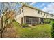 View of the back of the house, with a screened-in patio, lawn, and landscaping at 1259 Ribolla Dr, Palm Harbor, FL 34683