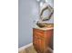 Stylish bathroom featuring a unique vessel sink, decorative mirror, and granite countertop at 1259 Ribolla Dr, Palm Harbor, FL 34683