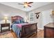 Beautiful bedroom features hardwood floors, a ceiling fan, and a large, decorative wooden sleigh bed at 1259 Ribolla Dr, Palm Harbor, FL 34683