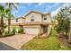 Lovely two-story townhome with terracotta roof, paved driveway, and well-maintained lawn at 1259 Ribolla Dr, Palm Harbor, FL 34683