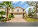 Inviting two-story home boasting a terracotta roof, brick driveway, and mature trees at 1259 Ribolla Dr, Palm Harbor, FL 34683