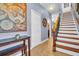 Elegant hallway featuring a wooden staircase, console table, and decorative wall art at 1259 Ribolla Dr, Palm Harbor, FL 34683