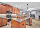 Modern kitchen with stainless steel appliances, center island, stylish backsplash, and plenty of counter space at 1259 Ribolla Dr, Palm Harbor, FL 34683