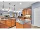 Open-concept kitchen with a center island, stainless steel appliances, and views into the adjacent living area at 1259 Ribolla Dr, Palm Harbor, FL 34683