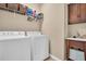 Laundry room featuring washer, dryer, sink and storage shelf at 1259 Ribolla Dr, Palm Harbor, FL 34683