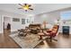 Comfortable living room with a plush sofa, area rug, ceiling fan, and natural light from the windows at 1259 Ribolla Dr, Palm Harbor, FL 34683