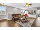Upstairs living room with a plush sofa, area rug, ceiling fan, and natural light from the windows at 1259 Ribolla Dr, Palm Harbor, FL 34683