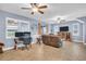 Inviting living area with tiled floors, ceiling fans, and ample natural light from windows and sliding glass doors at 1259 Ribolla Dr, Palm Harbor, FL 34683