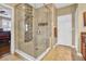 Tiled walk-in shower features a glass door and niche at 1259 Ribolla Dr, Palm Harbor, FL 34683