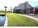 Grassy backyard with wrought iron fence and golf course views at 130 Water Oak Way, Oldsmar, FL 34677