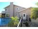 Charming backyard featuring a swimming pool, covered porch, and well-maintained landscaping at 130 Water Oak Way, Oldsmar, FL 34677