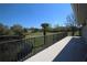 Overlooking a serene golf course with a picturesque pond, this balcony offers scenic community views at 130 Water Oak Way, Oldsmar, FL 34677