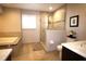 Elegant bathroom featuring a tiled tub, glass shower, and vanity with a marble countertop at 130 Water Oak Way, Oldsmar, FL 34677