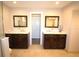 Bathroom with double vanities, neutral tile flooring, and framed mirrors at 130 Water Oak Way, Oldsmar, FL 34677