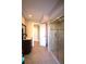 Bright bathroom boasts tiled shower, elegant vanity, and ample lighting offering a luxurious experience at 130 Water Oak Way, Oldsmar, FL 34677