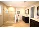 Bright bathroom featuring a spacious glass shower and modern vanity with marble countertop at 130 Water Oak Way, Oldsmar, FL 34677