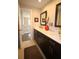Bathroom features a double vanity with dark wood cabinets and tiled floors at 130 Water Oak Way, Oldsmar, FL 34677
