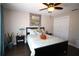 Comfortable bedroom featuring a ceiling fan, dark wood floors, and natural lighting at 130 Water Oak Way, Oldsmar, FL 34677