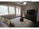 Bedroom with bright windows, hard wood floors and comfortable bedding at 130 Water Oak Way, Oldsmar, FL 34677