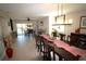 This spacious dining room, complete with a table for ten, seamlessly opens onto a picturesque lake view at 130 Water Oak Way, Oldsmar, FL 34677
