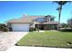 Inviting two-story home featuring a manicured front lawn and a spacious two-car garage at 130 Water Oak Way, Oldsmar, FL 34677
