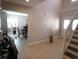 Open-concept foyer with tile flooring, a staircase, and a view to the dining room at 130 Water Oak Way, Oldsmar, FL 34677