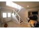 Bright foyer with staircase, glass railings, and views into the living room at 130 Water Oak Way, Oldsmar, FL 34677