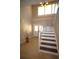 Bright foyer with staircase, tile flooring, and a large window at 130 Water Oak Way, Oldsmar, FL 34677
