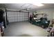 Spacious garage featuring an automatic door opener and plenty of room for a golf cart and storage at 130 Water Oak Way, Oldsmar, FL 34677