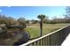 Balcony overlooking the golf course and pond, featuring lush greenery and mature trees at 130 Water Oak Way, Oldsmar, FL 34677