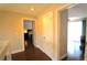 Second-floor hallway with hardwood floors and multiple entrances to rooms at 130 Water Oak Way, Oldsmar, FL 34677