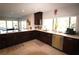 Modern kitchen with granite counters, stainless steel appliances, and tile flooring at 130 Water Oak Way, Oldsmar, FL 34677