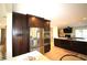 Kitchen featuring stainless refrigerator, dark wood cabinetry, and tile flooring at 130 Water Oak Way, Oldsmar, FL 34677