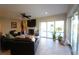 Bright living room with a fireplace and backyard access and pool views at 130 Water Oak Way, Oldsmar, FL 34677