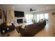 Spacious living room featuring a fireplace, large TV, and access to the backyard at 130 Water Oak Way, Oldsmar, FL 34677