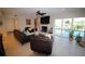 Cozy living room with fireplace and view of the pool and backyard at 130 Water Oak Way, Oldsmar, FL 34677