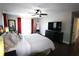 Nicely-appointed main bedroom with hardwood floors, ceiling fan, and bright curtains at 130 Water Oak Way, Oldsmar, FL 34677