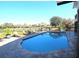 Sparkling in-ground pool surrounded by comfortable lounge chairs, overlooking a tranquil water view at 130 Water Oak Way, Oldsmar, FL 34677