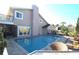 Lush backyard with large pool, deck chairs, screened lanai, and water view at 130 Water Oak Way, Oldsmar, FL 34677