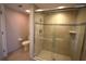 Modern tiled shower with seamless glass doors showcasing the elegant design and cleanliness of the bathroom at 130 Water Oak Way, Oldsmar, FL 34677