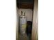 Small utility closet with water heater, extra chairs and shelves at 130 Water Oak Way, Oldsmar, FL 34677