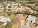 This overhead photo shows the backyard and covered pool, with a neighborhood visible in the background at 13542 Summerwood Ct, Hudson, FL 34667